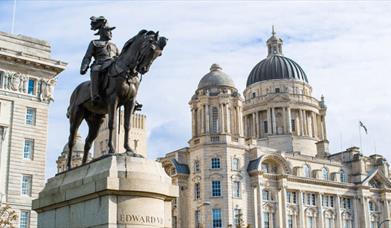 Statue of Edward VII on a horse in front of the Three Graces buildings