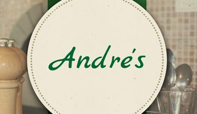 Andre's with a background of a pepper grinder and a glass with spoons inside