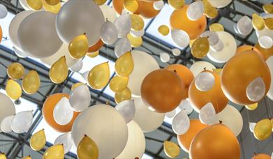 White and gold balloons tied to a string
