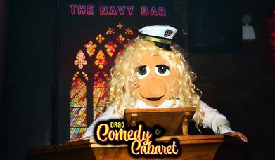 Miss piggy from the muppets dressed in a sailor outfit