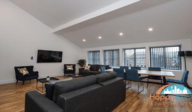 A sofa with a table and chairs.