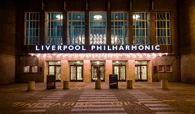 An Art Deco deco building reads 'Liverpool Philharmonic' in bright lettering