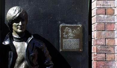 John Lennon statue next to the Liverpool Wall of Fame
