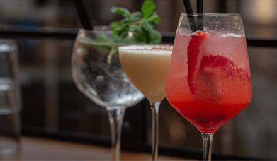 Three cocktails in glasses.