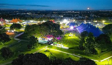 A night time shot of Sherdley Park in St Helens with lots of big top tents, crowds and lights