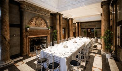 World Museum event space set out in a long dining table setting.