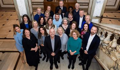 The Spectra DMC team standing together smiling.