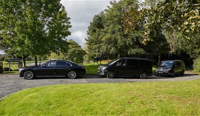 Three Mercedes cars parked up.