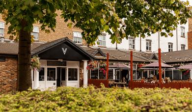 An exterior image of Village Hotel reception.