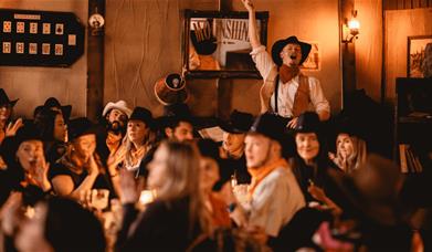 Moonshine Saloon Liverpool with a group of people enjoying the scene.