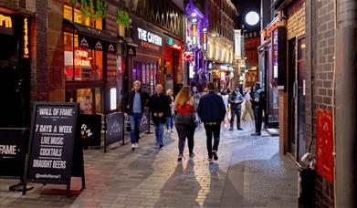 People walking down the world famous Mathew Street.