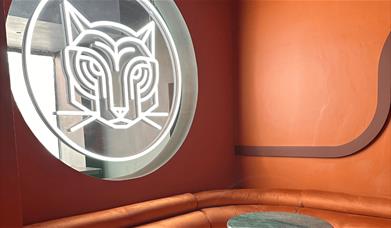 A light Tiger sign on a window