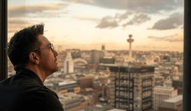 Gino looking out of the Sky Bar towards the city.